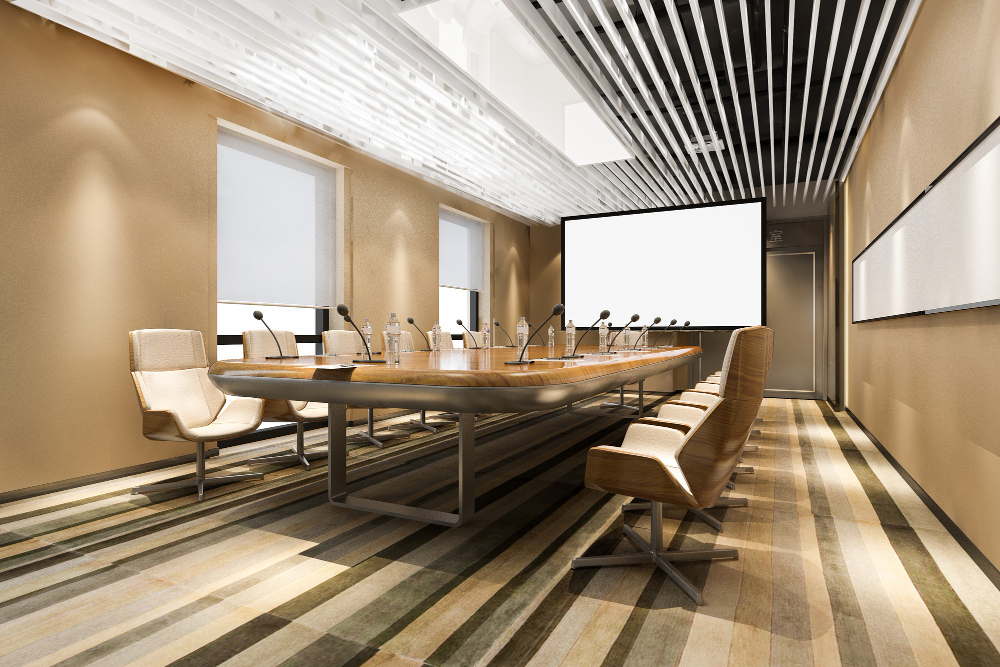 A-modern-conference-room-featuring-a-large-screen-at-the-front-and-several-chairs-arranged-for-attendees.jpg