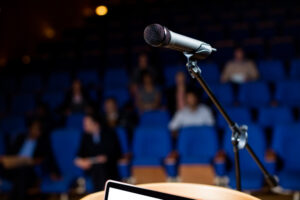 A microphone and laptop placed on a podium at the best travel agency in Dubai.