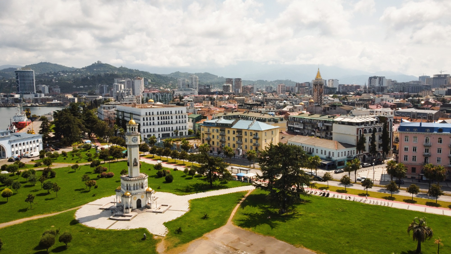 Panoramic-view-of-Tbilisi-showcasing-its-diverse-architecture-amidst-lush-green-grass.jpg
