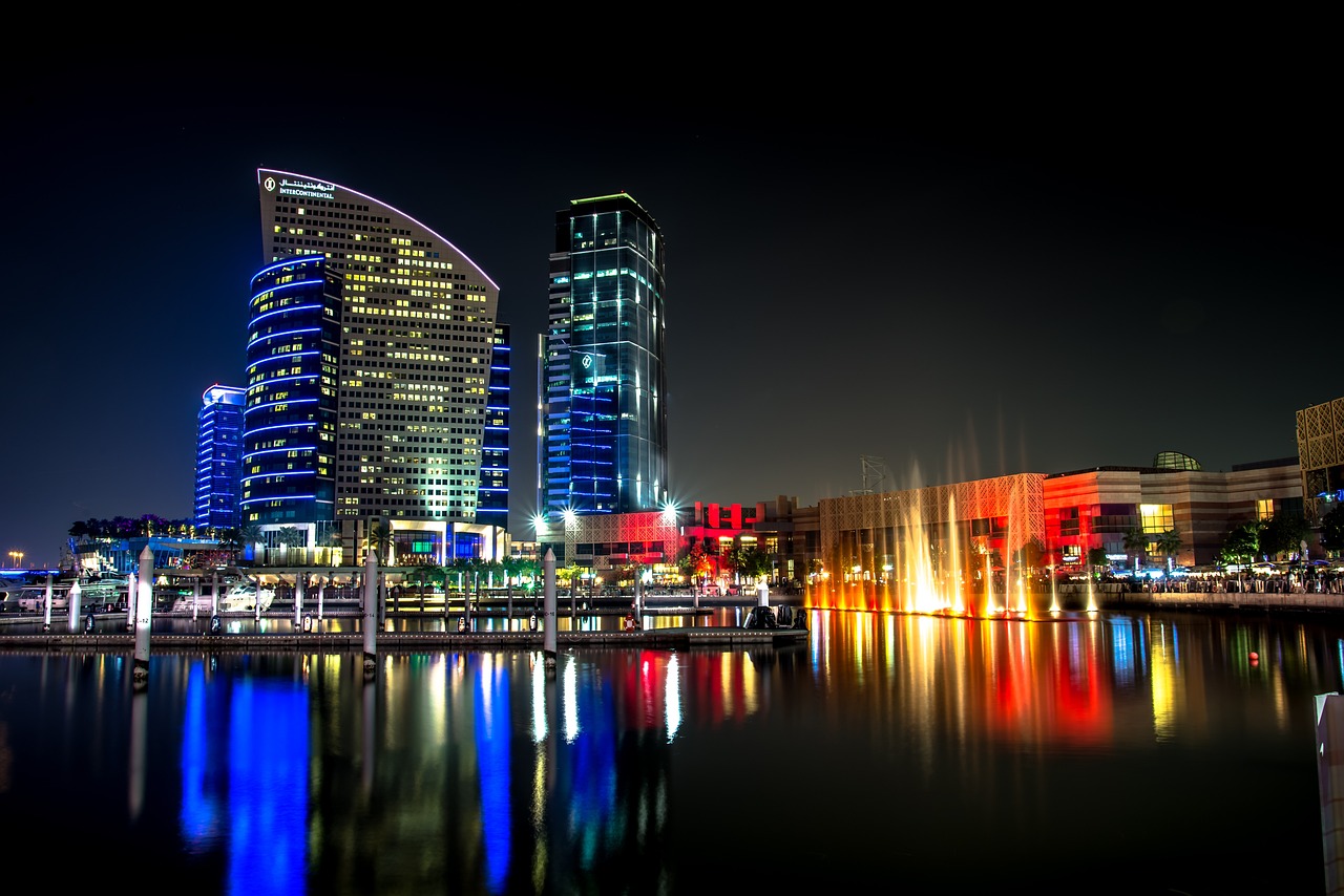 A serene view of a large body of water reflecting the vibrant lights of Dubai during Diwali celebrations.