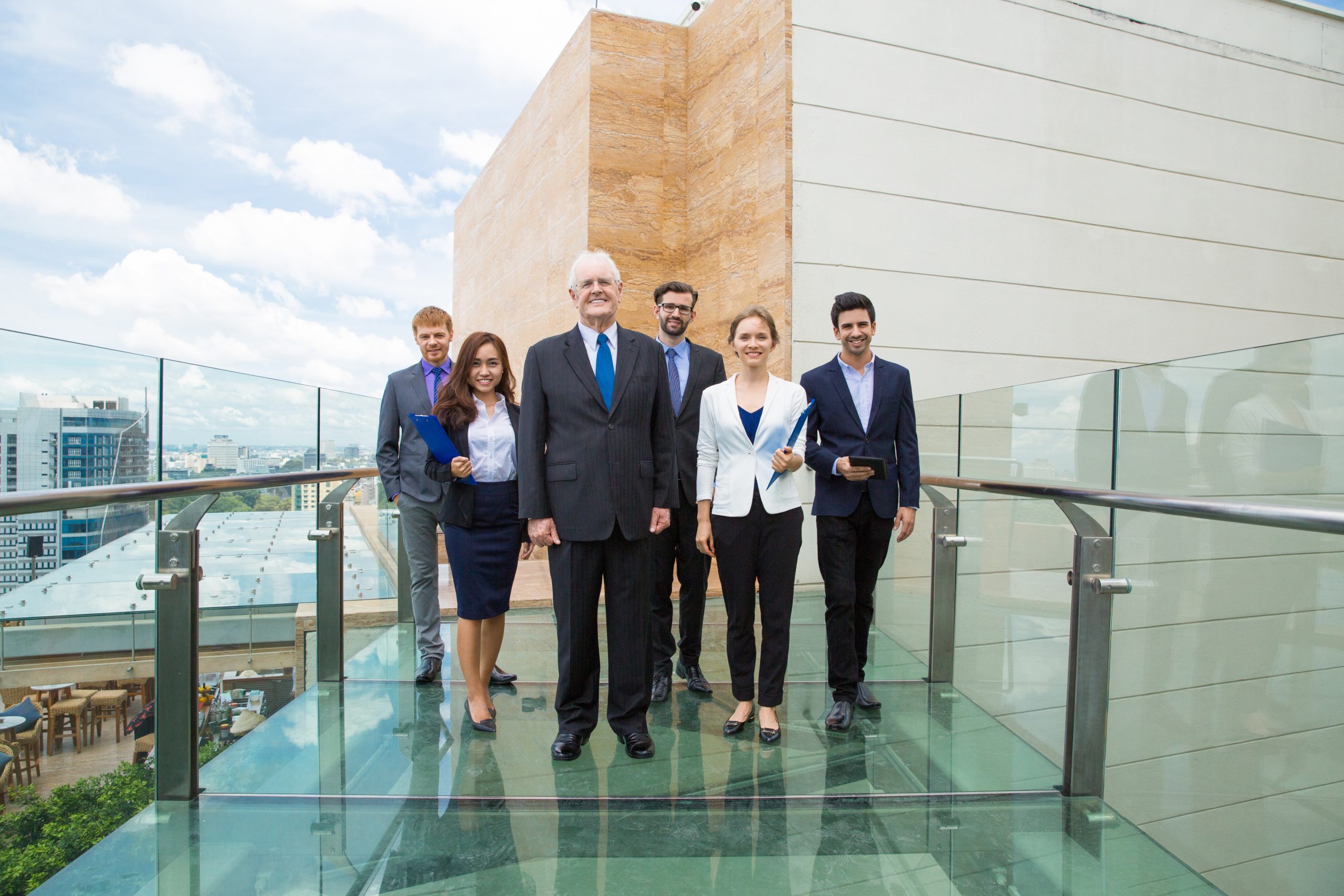 Business professionals on a glass walkway at the Tourism, Hotel Investment & Networking Conference Middle East 2025.jpg
